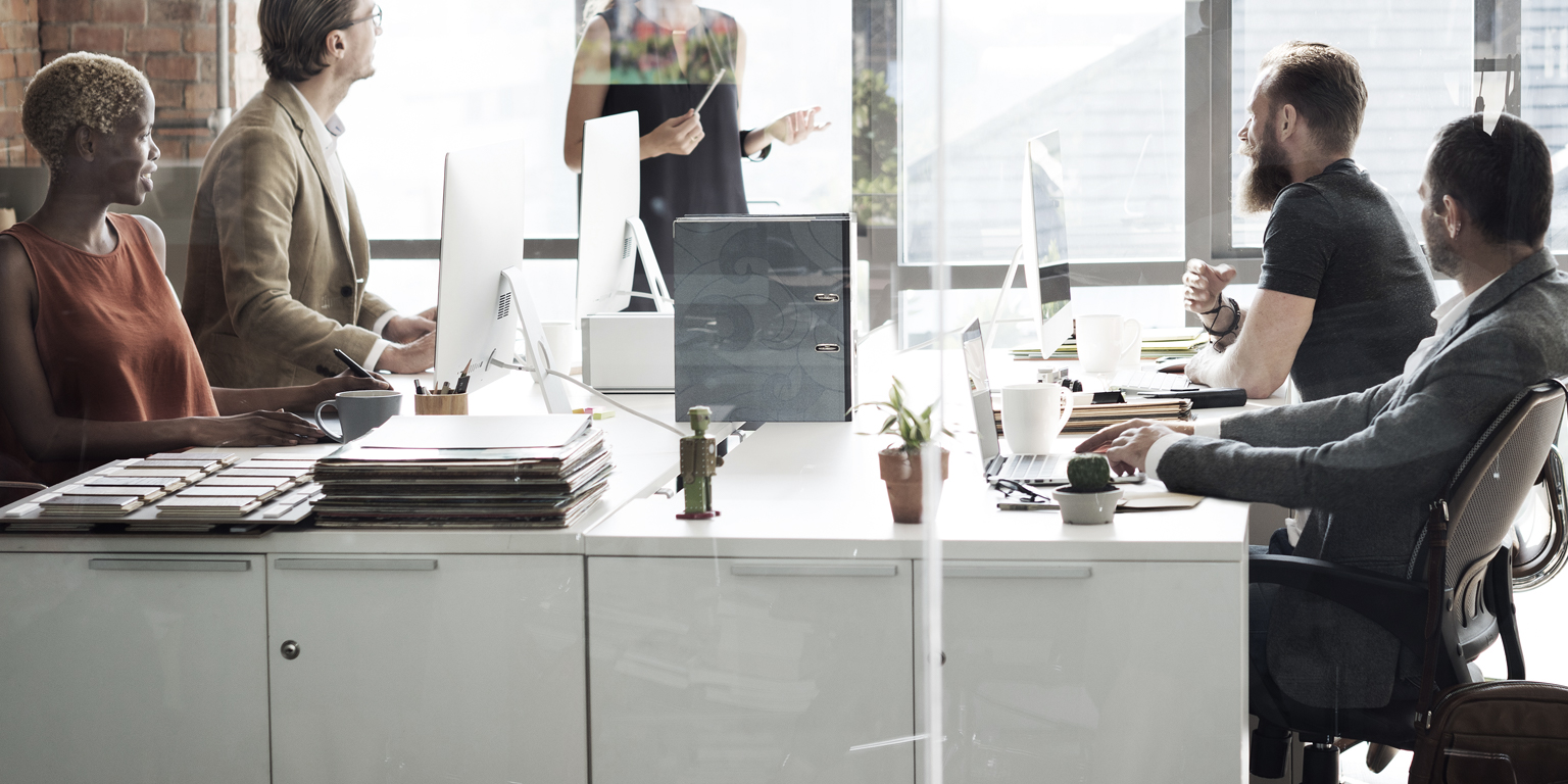 interior shot of people working with city background out windows