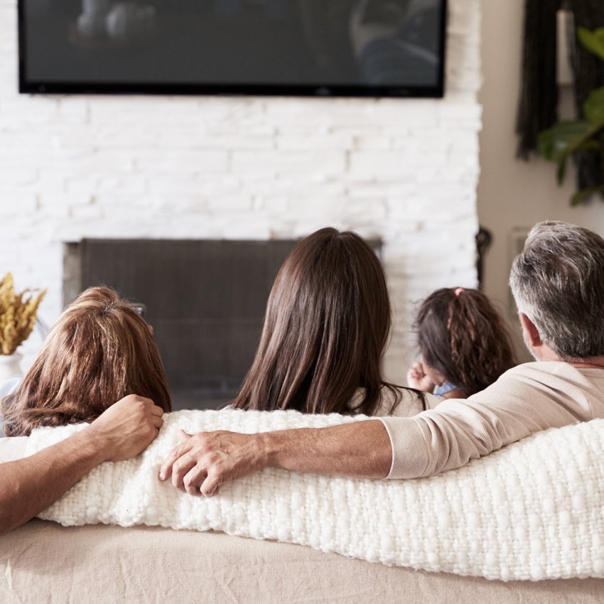 family on couch watching tv