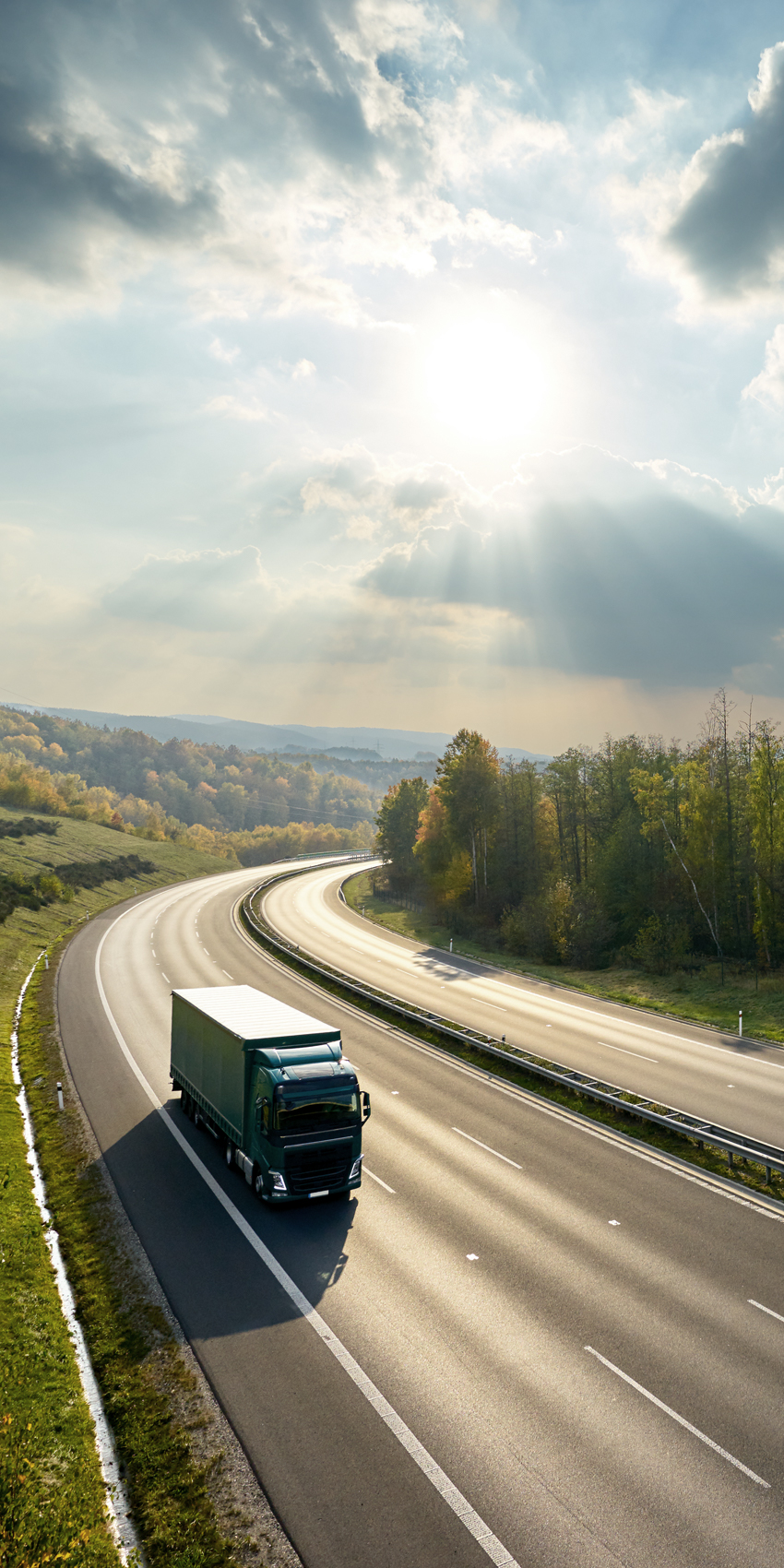 big rig truck driving on beautiful highway