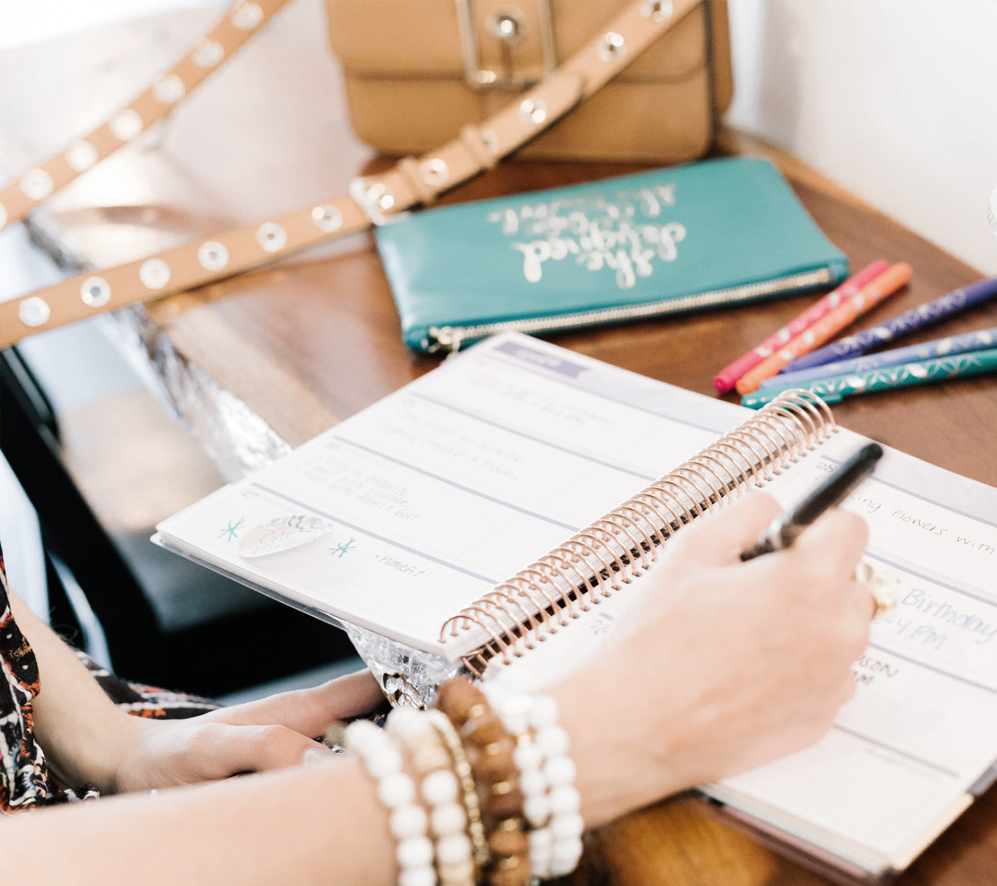 Woman writing in planner