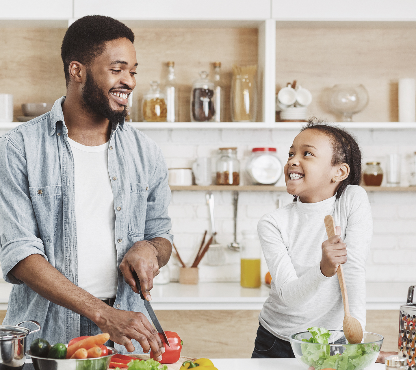 Father and daughter cooking together