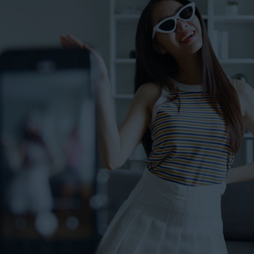 two women dancing in front of a phone