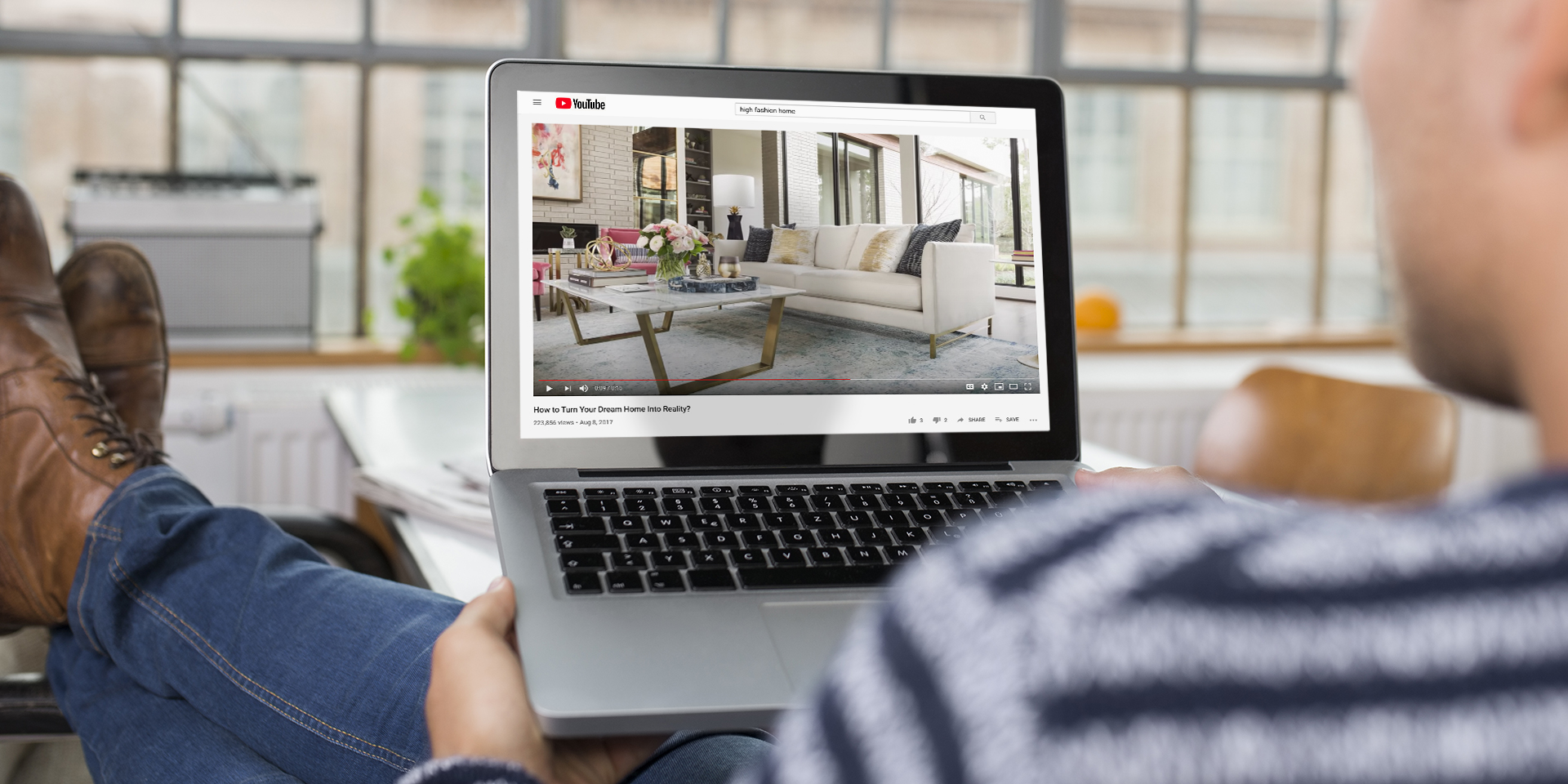 Man sitting at dining table watching youtube