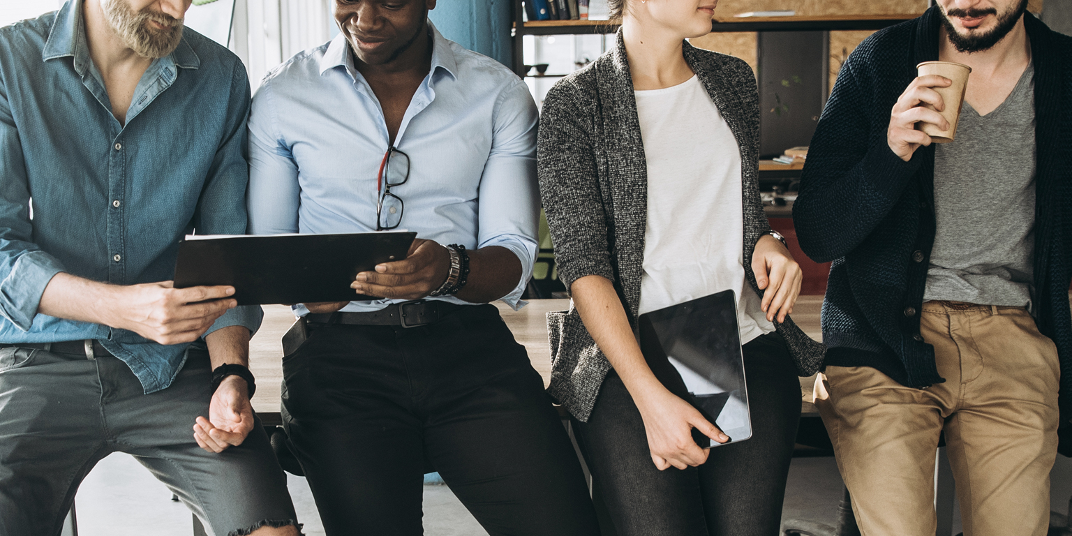 four people in office chatting